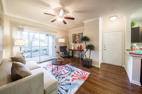Living room with wood-style floors and balcony/patio entrance,